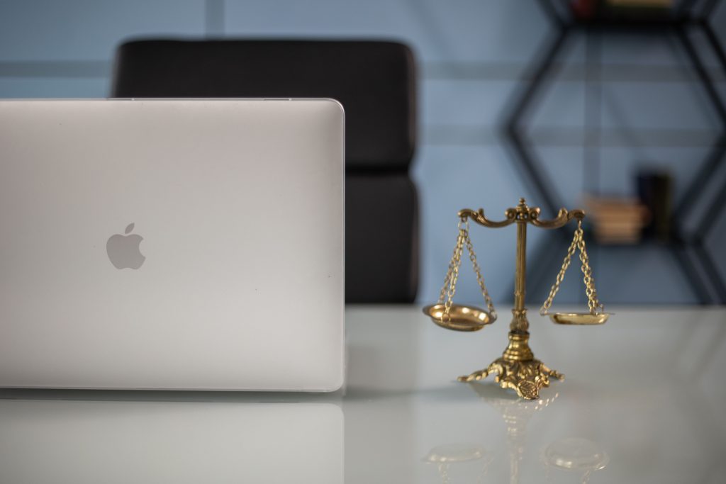 pexels-photo-6077665-6077665 Elegant balance of technology and justice scales on an office desk.